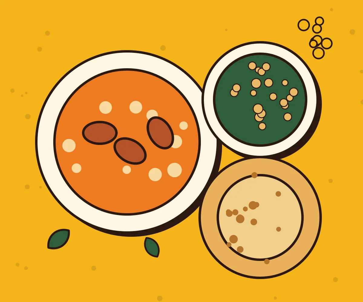 Bowls of curry, rice and flatbread on a yellow table